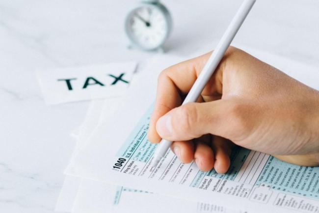 a photo of tax forms being completed by hand