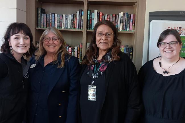 library employees and country representatives Patrice Horstman and Judy Begay pose together in front of the library booth at the 2025 High Country Stand Down